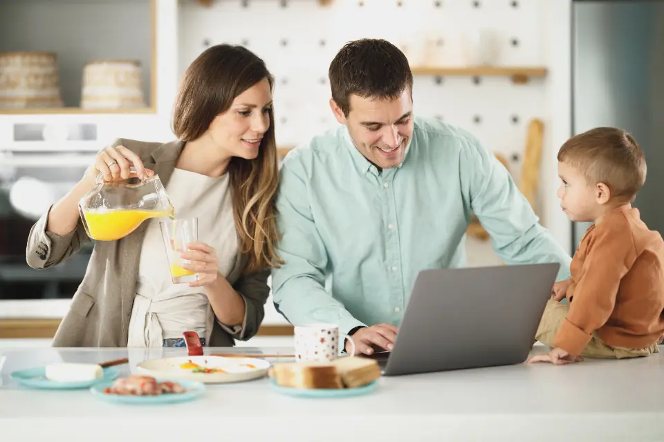 A family ordering at the kitchen table on a laptop